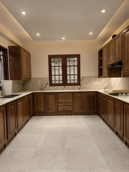 Fitted hardwood kitchen cabinetry with natural stone counters