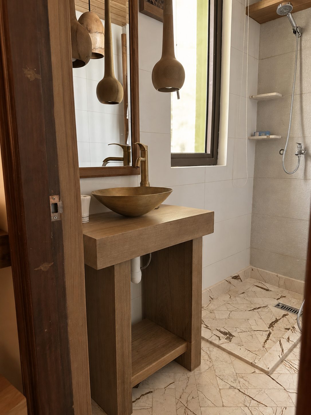 Marble bathroom with brass basin and teak vanity
